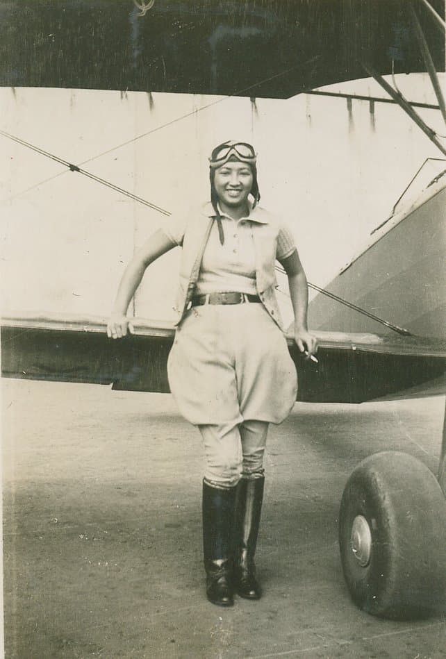 WASP pilot Hazel Ying Lee of Portland, standing beside her aircraft