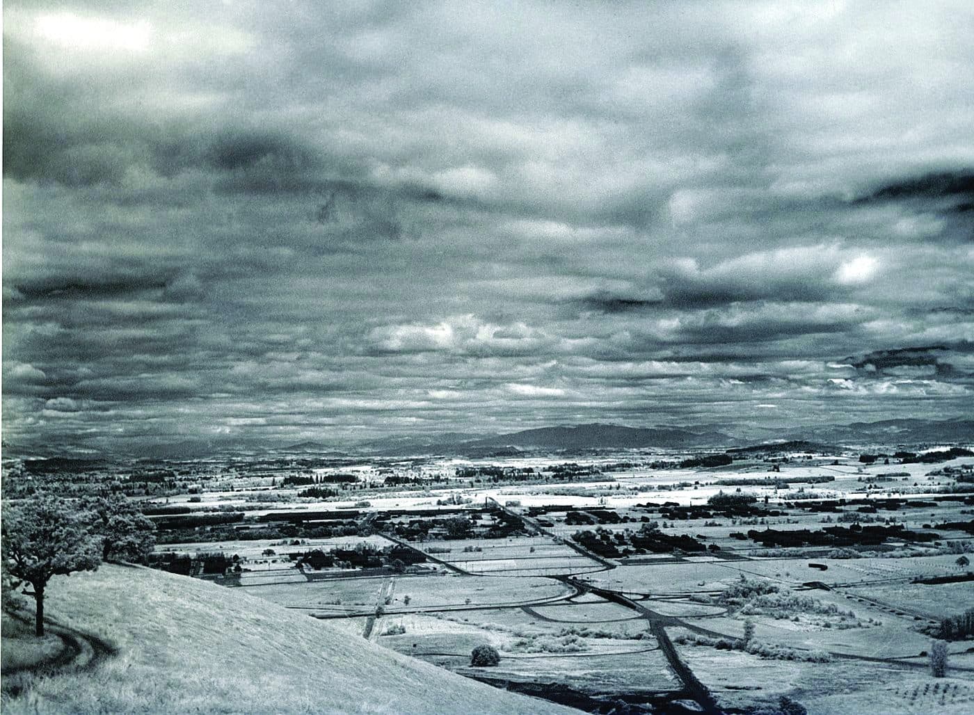 A wide Oregon valley under heavy cloud, the kind of ground troops trained on